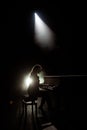 Female keyboards player on stage during concert, backlight