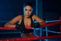 Female kickboxer resting after training.