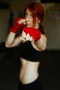 Female kickboxing fighter in gym