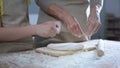 Female kid helping grandmother to roll dough for pizza, family recipe, cooking Royalty Free Stock Photo