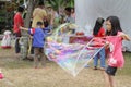 Female kids playing a big soap balloons