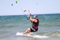 A female kite surfer rides the waves