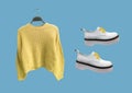 Female knit sweater and leather platform shoes. Composition of clothes