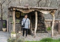 Female Korean tourist filling water jug at the water fountain of the Kasbah Du Toubkal mountain lodge in the High Atlas Mountains.