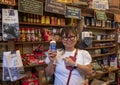 Female Korean tourist holds up a bottle labeled `Good Shit` in the historic Jefferson General Store in the City of Jefferson.