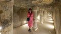 Female Korean tourist and stone columns reinforcing the passageway from the 2nd entrance on the south side of the Djoser pyramid.