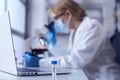 Female Lab Research Worker Wearing PPE Holding Test Tube Labelled BA.2 Royalty Free Stock Photo