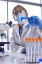 Female Lab Research Worker Wearing PPE Holding Test Tube Labelled BA.2 Royalty Free Stock Photo