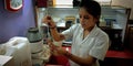 A female lab technician collecting urine sample at test tube Royalty Free Stock Photo