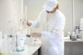 Female lab worker doing tests in a laboratory in an industrial c Royalty Free Stock Photo