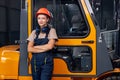 female labor worker near forklift driver in industry factory logistic shipping warehouse.