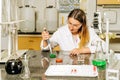 Female laboratory technician researching medical samples and reagents for coronavirus vaccination