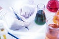 Female Laboratory Worker Dealing With Flasks Containing Liquid Chemicals Royalty Free Stock Photo