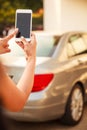 Female Lady using app on smart phone device, technology concept. Lady hand using remote control to send signal to unlock car doors