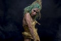 Female Latin woman with green hair and gold costume with handmade flourishes, fantasy image and tale