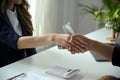 A female lawyer or business legal consultant receives a bribe or tribute from her client Royalty Free Stock Photo