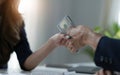 A female lawyer or business legal consultant receives a bribe or tribute from her client in the office. Corruption Royalty Free Stock Photo