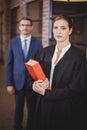 Female lawyer with businessman standing in background Royalty Free Stock Photo