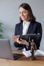 female lawyer conducts an online consultation from a laptop via video link for a client. work in a law firm checking