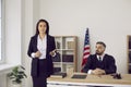 Female lawyer or defense attorney speaking to judge and audience during court trial