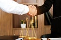 Female lawyer handshake with client. Business partnership meeting successful concept.