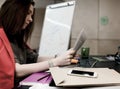 Female Lawyer reading Contract with Business Items around