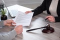 Female lawyer showing a document to her client