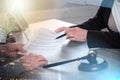 Female lawyer showing a document to her client; multiple exposure