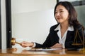 A female lawyer working with laptop, hammer in lawyer`s office with the goddess of justice with scales, advice, and concepts of ju Royalty Free Stock Photo