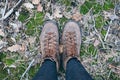 Female leather vintage boots standing on green moss background