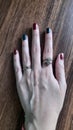 Female left hand rings red teal nailpaint Royalty Free Stock Photo