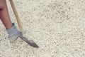 Female diggings stone for the cement with shovel. Royalty Free Stock Photo