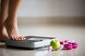 Female leg stepping on weigh scales with measuring tape, pink dumbbell and green apple. Healthy lifestyle, food and sport concept Royalty Free Stock Photo