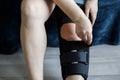 Female leg wearing knee brace. Rehabilitation for knee injury Royalty Free Stock Photo