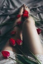 Female legs and beautiful red tulips. Stll life. Grainy effect. Copy space. Flowers composition Royalty Free Stock Photo