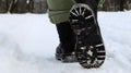 Female legs in black boots, winter walk in the snow. Active woman walking away from the camera in the winter forest. Focus on your Royalty Free Stock Photo