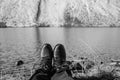 Female legs in black hiking boots against the background of snow mountains in Switzerland. Snow on women`s shoes Royalty Free Stock Photo