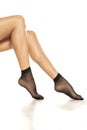 Female legs in black short nylon socks on white Royalty Free Stock Photo