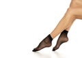 Female legs in black short nylon socks on white Royalty Free Stock Photo