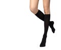 Female legs in black socks on white background Royalty Free Stock Photo