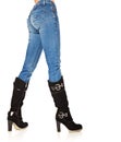 Female legs in a blue jeans and high boots Royalty Free Stock Photo