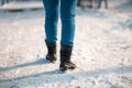 Female legs close up rear view. The snow in the background. Copy space