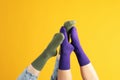 Female legs in color socks on yellow background Royalty Free Stock Photo