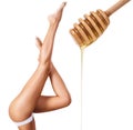 Female legs depilation by honey or sugar pasta.