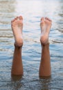 Female legs and feet upside down in the water Royalty Free Stock Photo