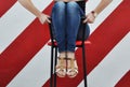 Female legs and feet. woman sit on chair in jeans and leather sandals. coziness and relaxation. home and office interior design. Royalty Free Stock Photo