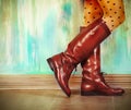 Female legs in high brown leather boots Royalty Free Stock Photo