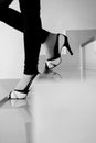 Female legs in high heels walking down stairs, black and white Royalty Free Stock Photo