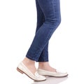 Female legs in jeans classic lacquer white shoes moccasins