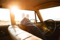 Female legs leaning out of the car window Royalty Free Stock Photo